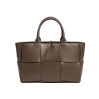 Front view of Aurelia brown genuine leather tote bag with woven texture, leather handles, and a tie closure