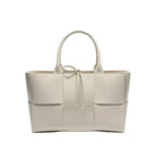 Front view of Aurelia off-white genuine leather tote bag with woven texture, leather handles, and tie closure