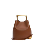Front view of a Brown Izelia top grain leather crossbody bag with gold handle on a white background