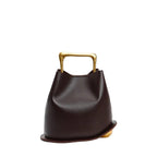 Front view of a Coffee Izelia top grain leather crossbody bag with gold handle on a white background