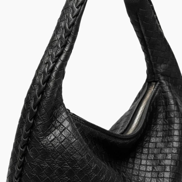 Valencia Vegan Leather Hobo Bag in black, close-up of braided handle and woven grain with metal zipper detail