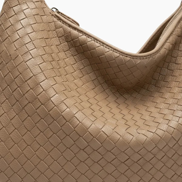 Close-up of khaki woven vegan leather hobo bag with zipper closure and smooth texture