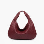 Front view of wine red woven vegan leather hobo bag with wide handle, zipper opening, and detailed texture