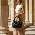 Valencia Vegan Leather Hobo Bag in black, model holding woven crescent hobo to showcase elegant everyday style