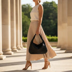 Valencia Vegan Leather Hobo Bag in black, lifestyle walking shot highlighting chic crescent silhouette for day to night